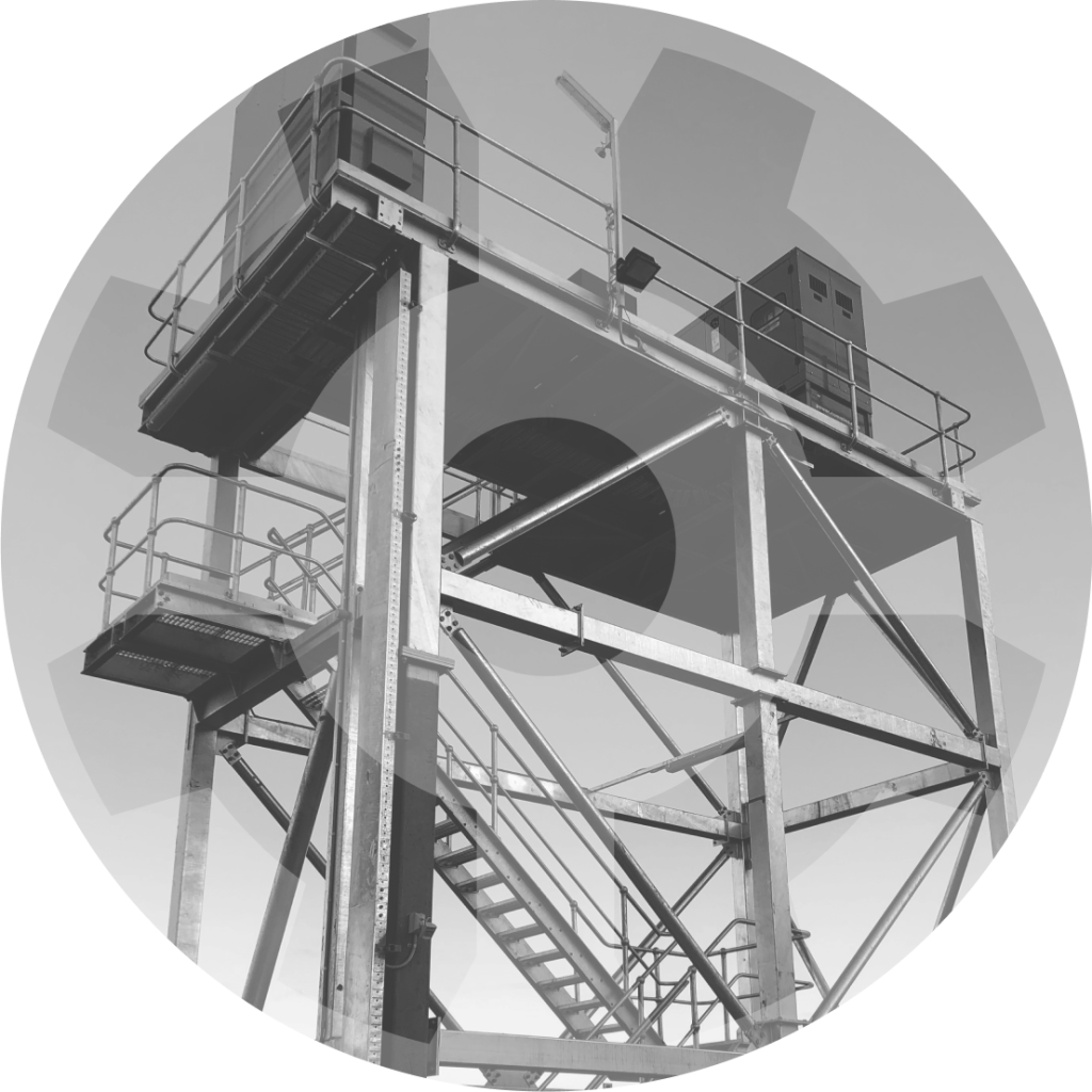 A black and white image of a tower with stairs.